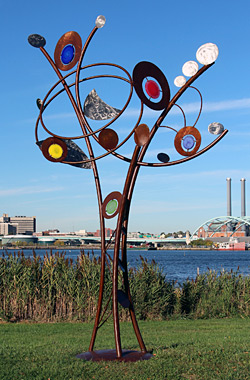 In Whitmore Boogaerts' hands, sculpture can reach for the sky at ten to twenty feet and may incorporate kinetic movement. "Cosmic Directions", steel, stainless steel and glass. 8' x 4' x 13'