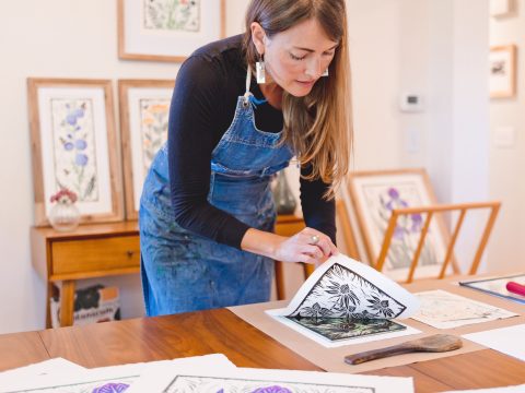 Printmaker Sarah Hess pulls one of her botanical art prints.