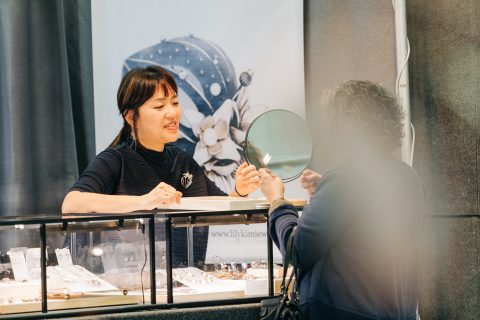 A patron tries on jewelry at Lily Kim Jewelry.